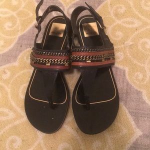 Black sandals with brown and gold detail